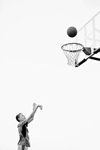 boy child shooting a basket playing basketball 