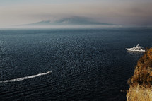 Boat at sea leaving a wake. boat in the sea, mountain on the background of the sea. Sorrento, view over Neapolitan Bay