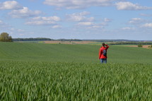 a person standing in a green field 