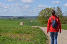 woman walking down a country road 