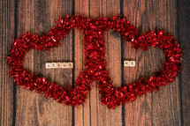 Two red hearts with game tiles spelling "Jesus" and "Me" in the center.