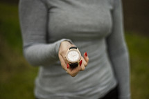 a woman holding a watch 