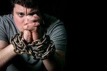 a man with arms in chains 