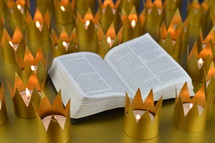 opened Bible and crown votives 