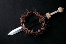swords and crown of thorns on a black background 