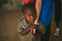 innocent child holding the hand of a missionary 