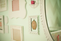 frames and mirrors hanging on a wall 