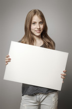 teen girl holding a blank sign 