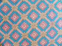 A fabric book cover to cover a bible or book that is a fabric tapestry of blue, mauve, gold and yellow fabric design to cover a book to protect the cover from wear and tear when taking to church, bible study or decorate an old book. 