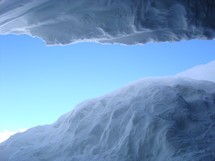 View out of a glacier cave into the bright sky,
