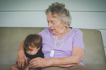 grandmother sitting with her infant grandson 