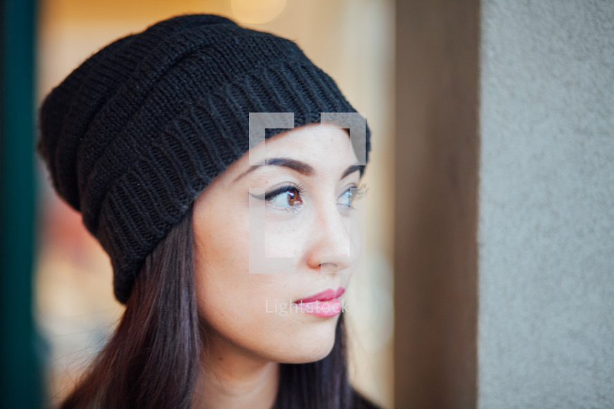 head shot of a young woman wearing a wool cap 