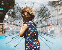 a girl child at a splash park 