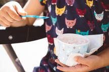 a girl child eating ice cream 