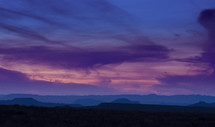 Silhouette of a mountain range at dusk.