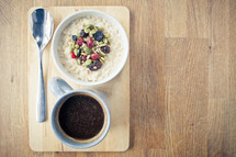 porridge with seeds and fruit and a coffee mug 