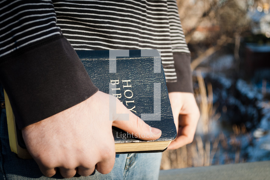 young man holding a Bible