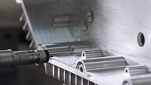 Macro footage of a coordinate measuring machine CMM measuring metal part