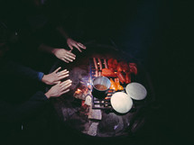 warming your hands over a fire and cooking food 