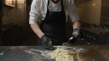 Italian Professional Chef Making The Homemade Pasta At Restaurant Table