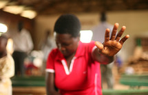 Woman in worship service with raised hands
