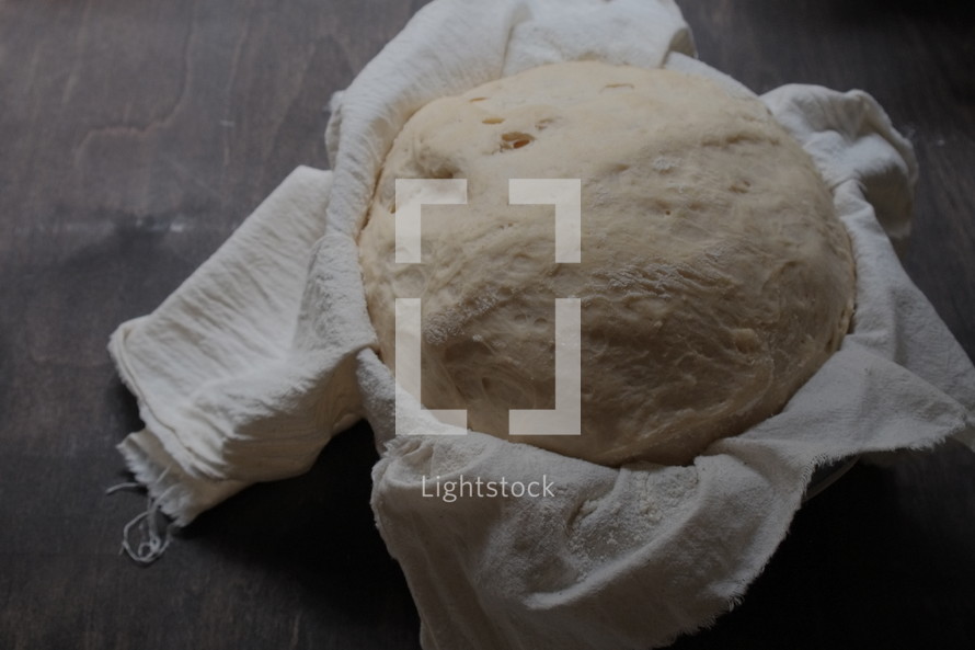 Making bread - dough rising in cloth