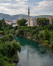 Koski Mehmed Pasha Mosque on the banks of the Neretva River in Mostar, Bosnia and Herzegovina on a sunny day