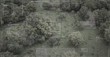 Military drone view of soldiers walking through a forest