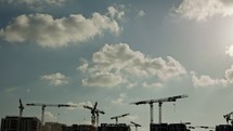 Large construction site with many cranes working over buildings
