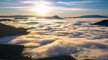 Magic sunrise above foggy clouds motion in alpine valley nature in spring morning landscape hyper time lapse
