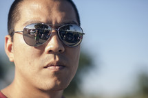 face of a man in sunglasses 