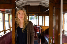 woman standing in a train car 