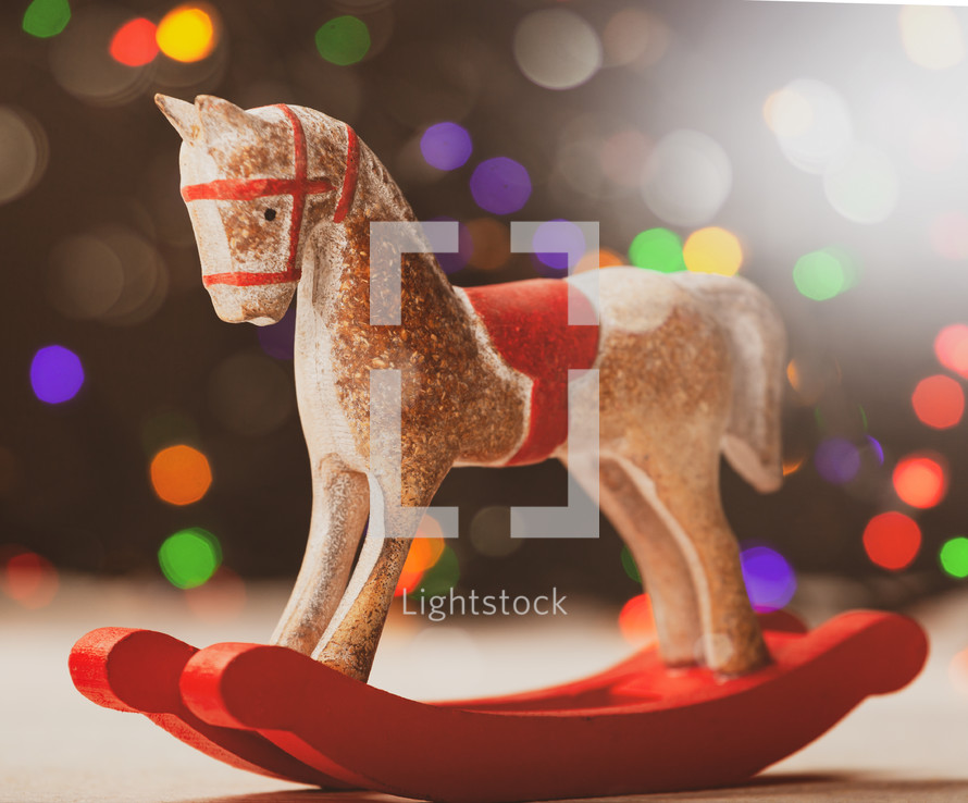 rocking horse ornament and colored bokeh lights 