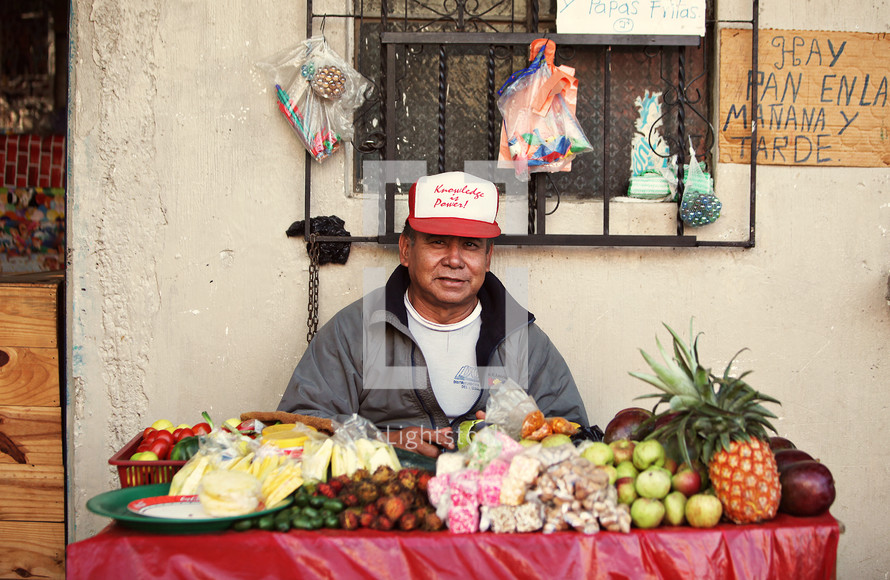 Man selling fruit on table