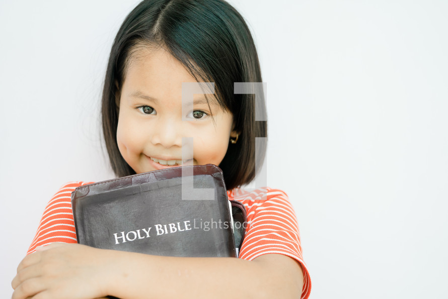 child holding a Holy Bible 