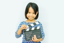 girl holding a clapper board 