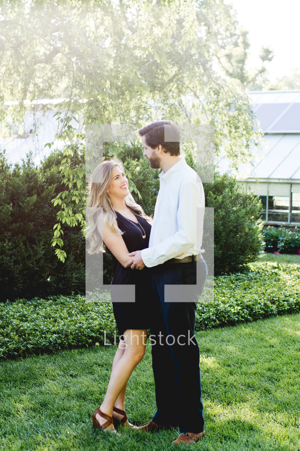a couple standing together in the grass