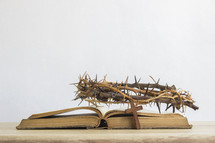 crown of thorns, Bible and cross on a desk 