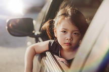 Unhappy sadness, Asian girl in car going to a foster home