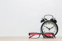alarm clock and reading glasses 