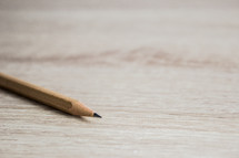 sharpened pencil on a wood background with copy space