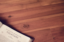 BIble on a wood floor opened to Galatians 