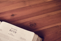 BIble on a wood floor opened to Ruth 