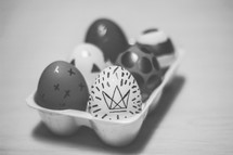 decorated Easter eggs in a carton 