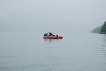 men floating in a raft at sea 