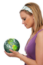 Woman with a green earth in her hands.