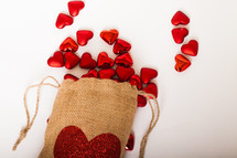 red hearts and a burlap sac on a white background 