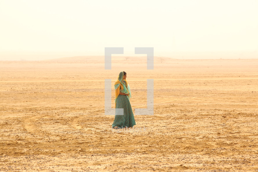woman standing in a desert 