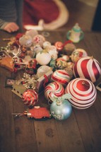 Christmas ornaments lying on wooden table.