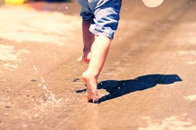 A child running through a puddle